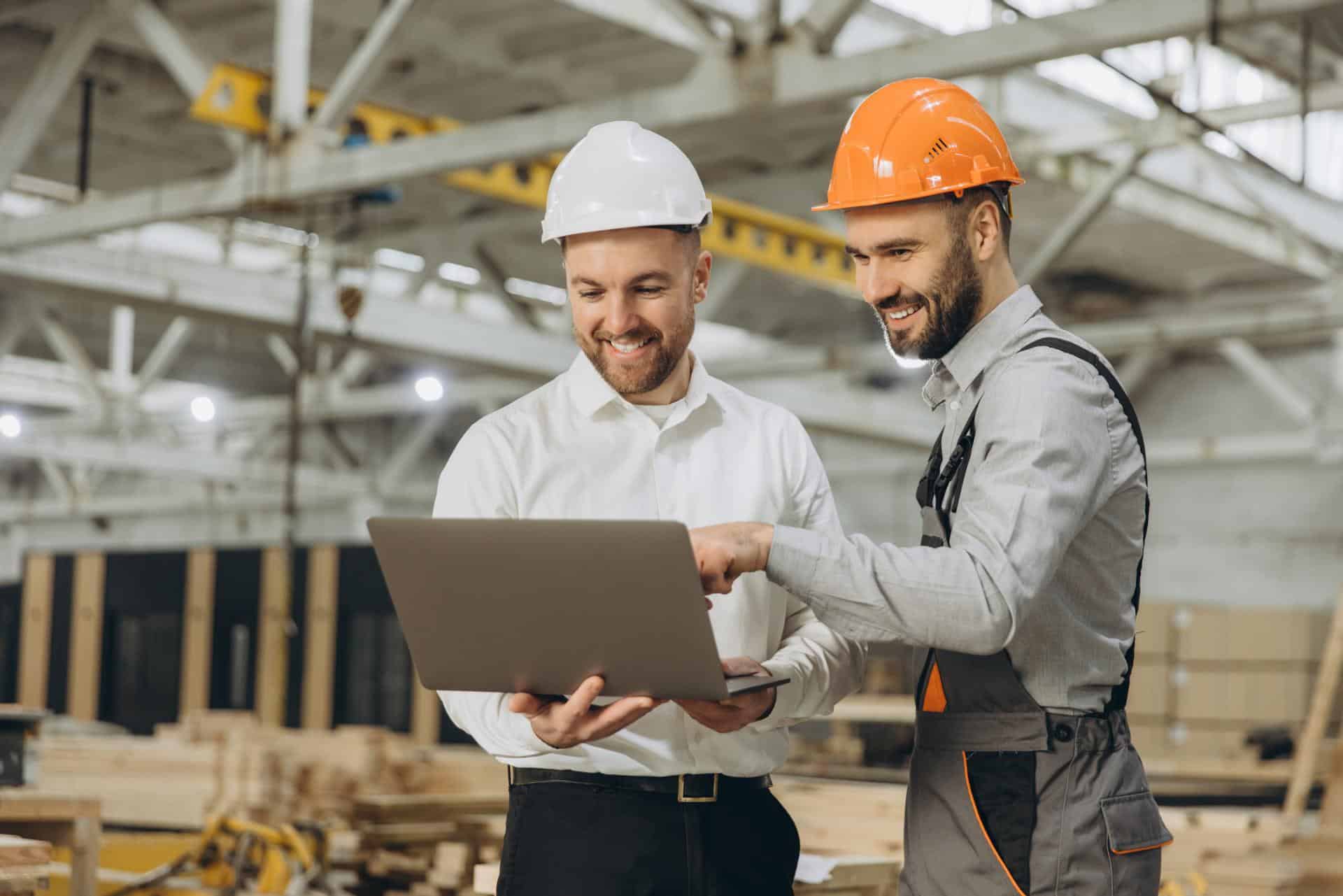 2 men looking at a laptop